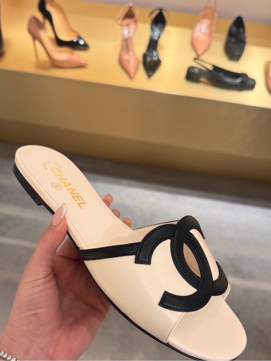 CHANEL Shoes - CHANEL Cream and Black Leather CC Slide Mule